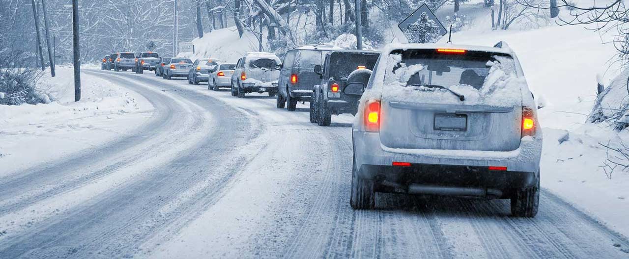 Cars driving on a snow packed road
